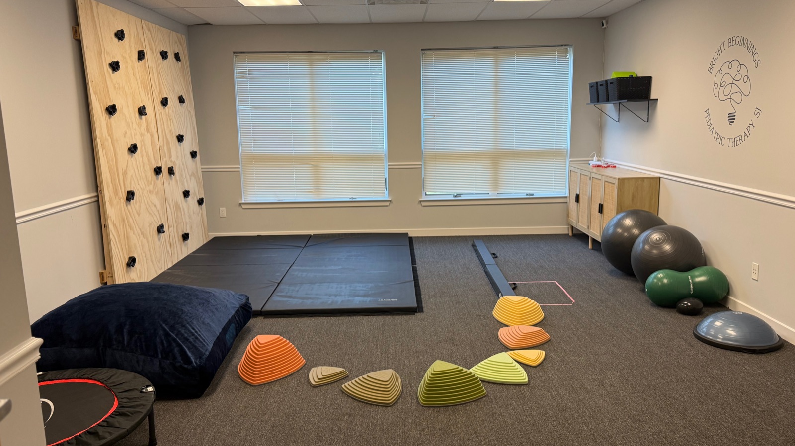 Gross-motor gym with climbing and movement equipment for building coordination and strength